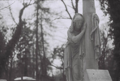 Low angle view of statue against trees