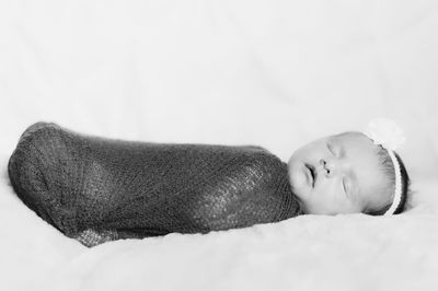 Portrait of cute baby sleeping on bed