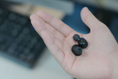 Close-up of human hand holding black background