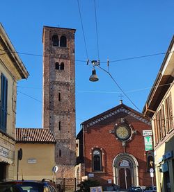 Low angle view of buildings against clear blue sky