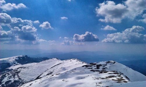 Scenic view of snow covered mountains against sky