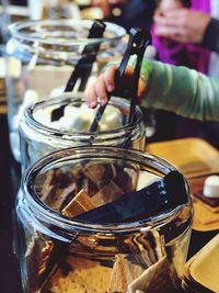 Close-up of hand holding ice cream in jar