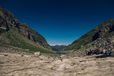 Scenic view of mountains against clear blue sky