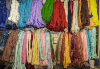 Full frame shot of multi colored threads hanging at market stall