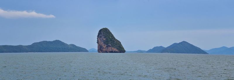 Rock formations in sea against sky