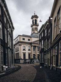 Street amidst buildings in city against sky