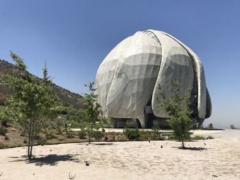 Built structure on beach against clear sky