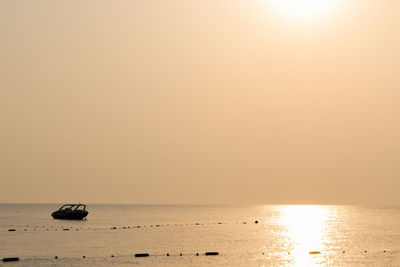 Scenic view of sea against clear sky during sunset