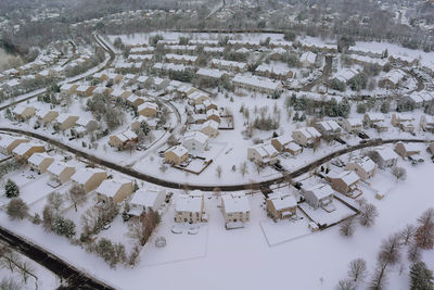 High angle view of snow covered roof and buildings in city