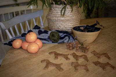 Close-up of gingerbread in basket on table, dog shaped cookies and fruit at christmas 
