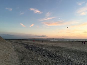 Scenic view of beach against sky during sunset