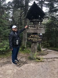 Full length of man standing in forest
