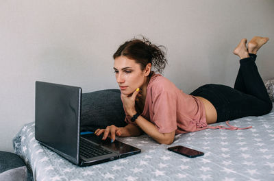 Young woman using laptop at home