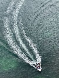 High angle view of people riding boat in sea