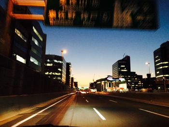 Illuminated city street at night