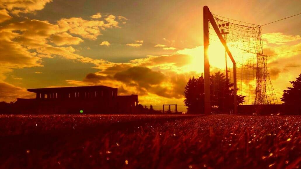 sunset, architecture, built structure, building exterior, orange color, sky, silhouette, house, cloud - sky, field, nature, outdoors, rural scene, no people, sunlight, beauty in nature, tree, sun, residential structure, cloud