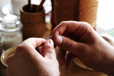 Close-up of hands rolling cigarette