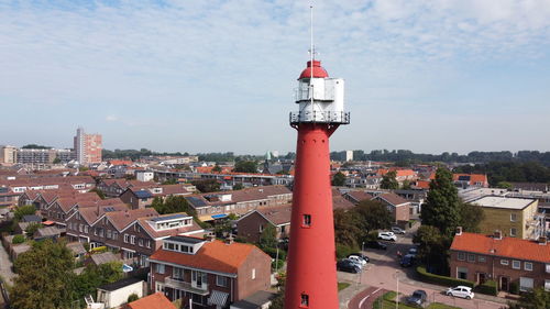 Lighthouse by sea against sky