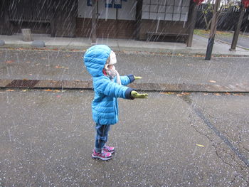 Side view of boy playing in snow