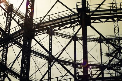 Low angle view of gasometer against sky