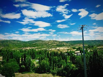 Scenic view of field against cloudy sky