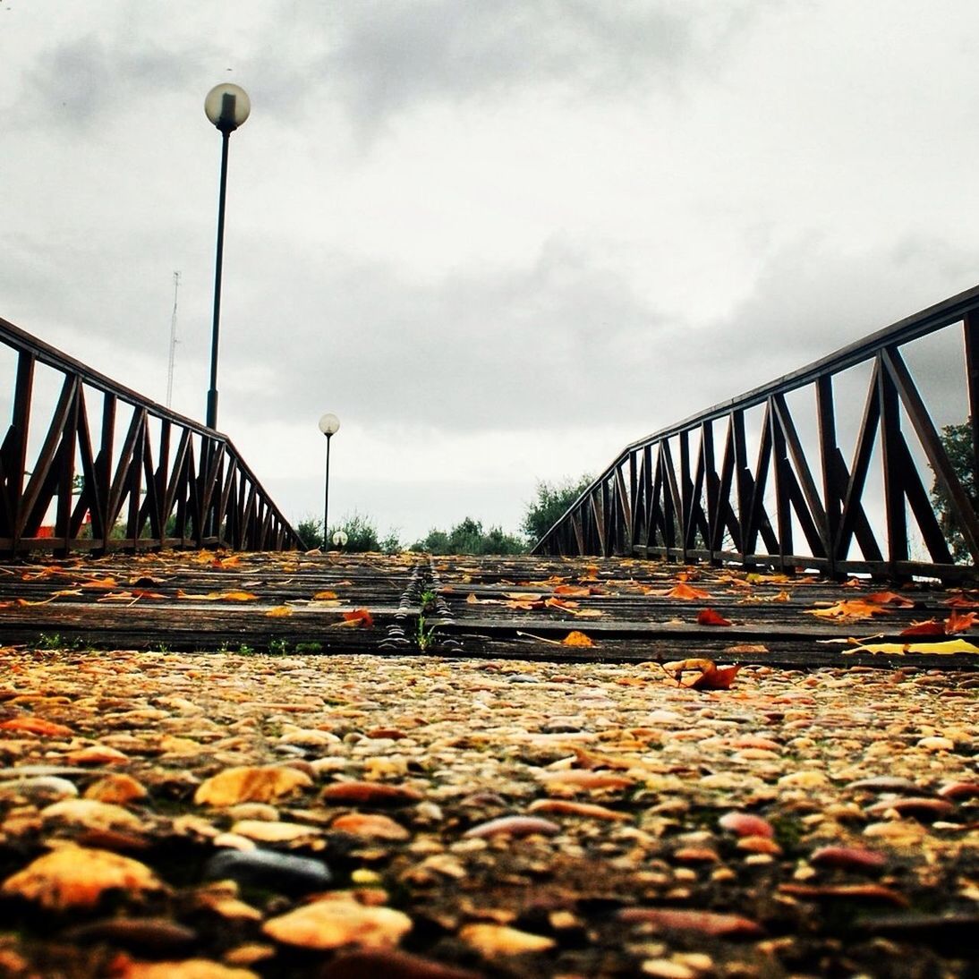 the way forward, sky, connection, diminishing perspective, bridge - man made structure, surface level, railing, long, cloud - sky, built structure, transportation, bridge, vanishing point, nature, street light, tranquility, cloud, water, outdoors, footbridge