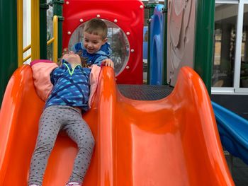 Boy playing on slide at playground