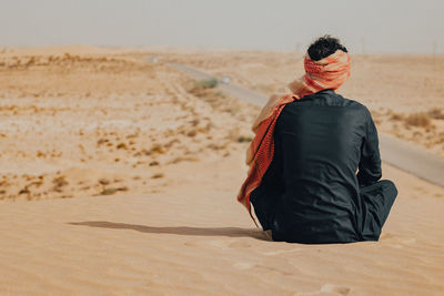 Rear view of woman standing at beach