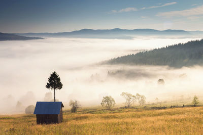 Scenic view of field and mountains against sky