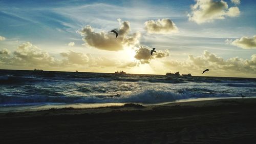 Scenic view of beach against sky during sunset