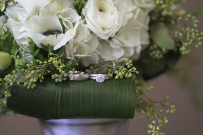 Close-up of rose bouquet and wedding rings