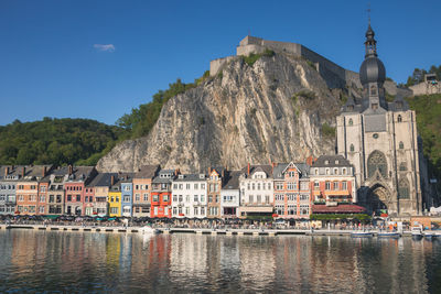 Buildings at waterfront against sky