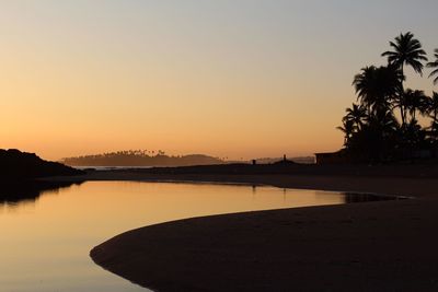 Scenic view of sea against clear sky during sunset