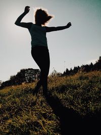 Woman jumping on field