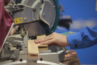 Midsection of carpenter working in workshop