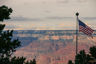 American flag waving against grand canyon national park