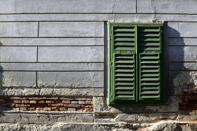 Closed window on wall of old building