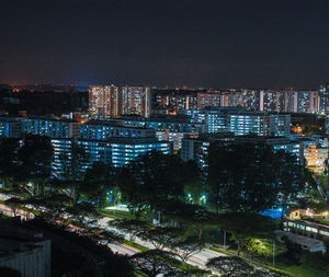 High angle view of illuminated buildings against sky at night
