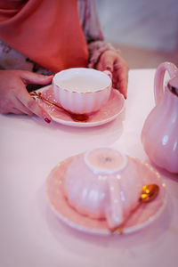 Midsection of coffee cup on table