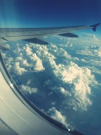 Cropped image of airplane wing over landscape