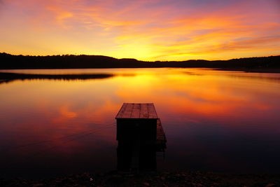 Scenic view of lake against romantic sky at sunset