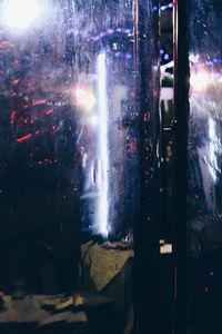 Close-up of illuminated window in winter at night