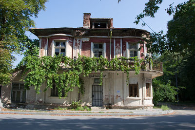 Exterior of historic building by trees against sky