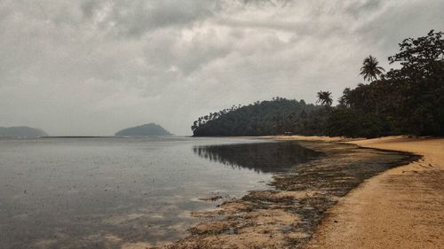 Scenic view of sea against cloudy sky