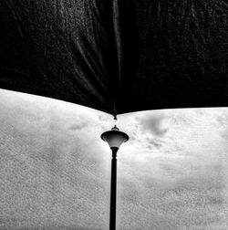 Low angle view of illuminated street light against sky