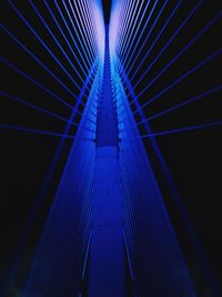 Low angle view of illuminated suspension bridge at night