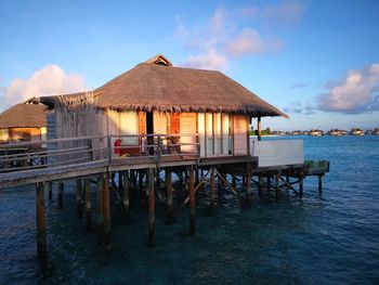 Built structure by sea against sky