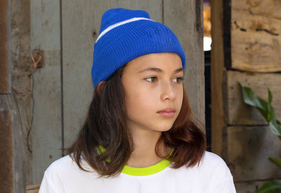 Beautiful girl model white asian teen wearing a woolen hat close up face