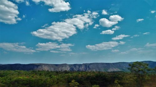 Scenic view of landscape against blue sky
