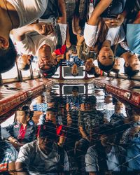 High angle view of people standing on table